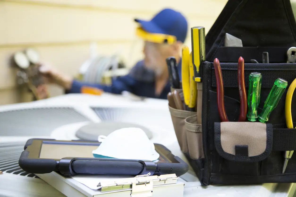 Technician services outside AC units and generator.